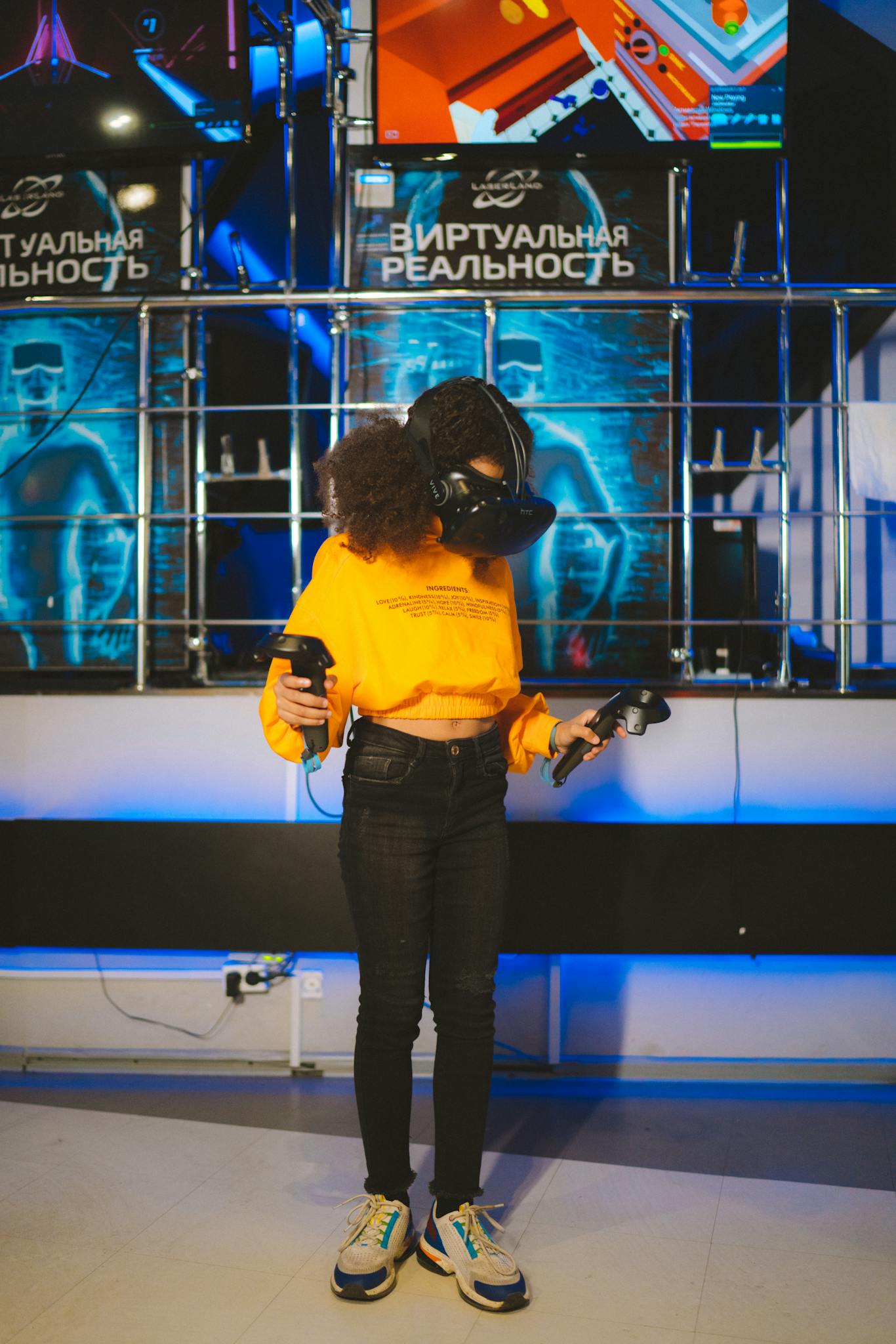 A child wearing a VR headset and controllers immersed in a virtual reality game indoors.